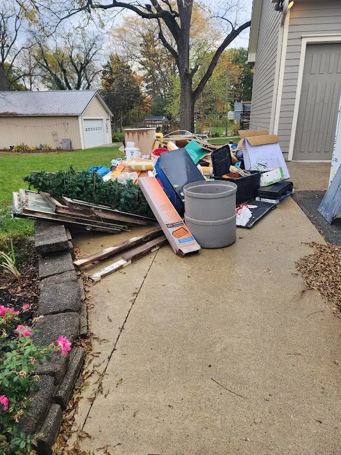 Dumpster being loaded with debris for 12 Yard Dumpster Rental in Cheshire